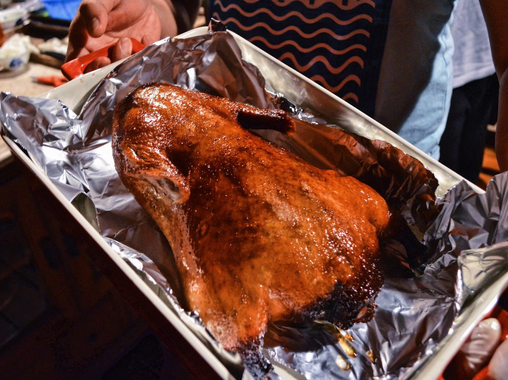 The golden brown roasted duck is ready to be served.