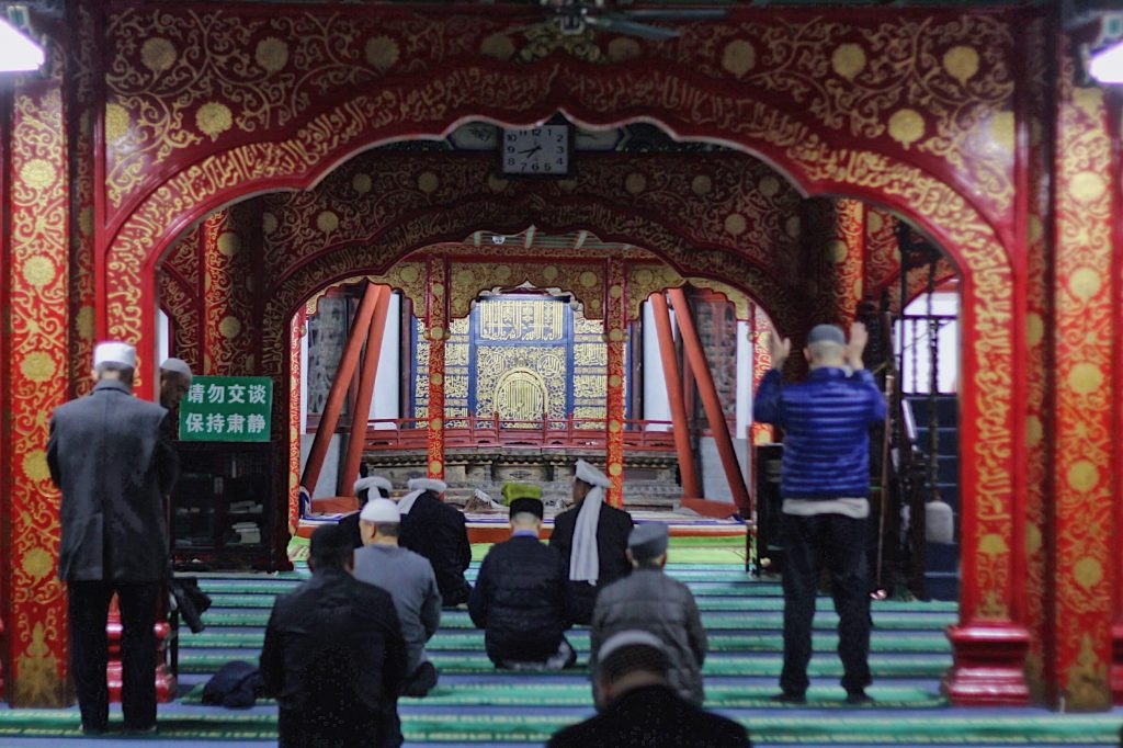 The Main Prayer Hall - adorned with various paintings of flowers, strings of glass beads and coloured glass on the ceiling.